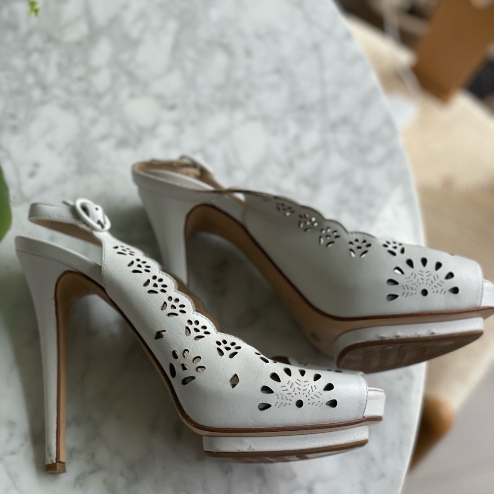 White leather high-heeled, opened-toed sandals.